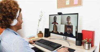 Manager showing how to onboard remote employees during a video call on a laptop