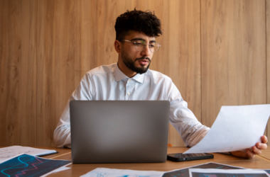 A business owner researching how US businesses cut costs during economic uncertainty