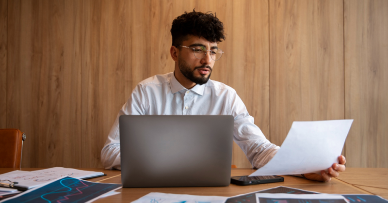 A business owner researching how US businesses cut costs during economic uncertainty